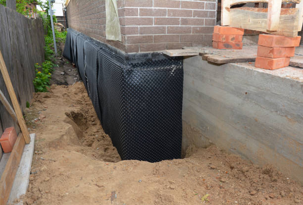Happy homeowners after waterproofing job in Saugatuck